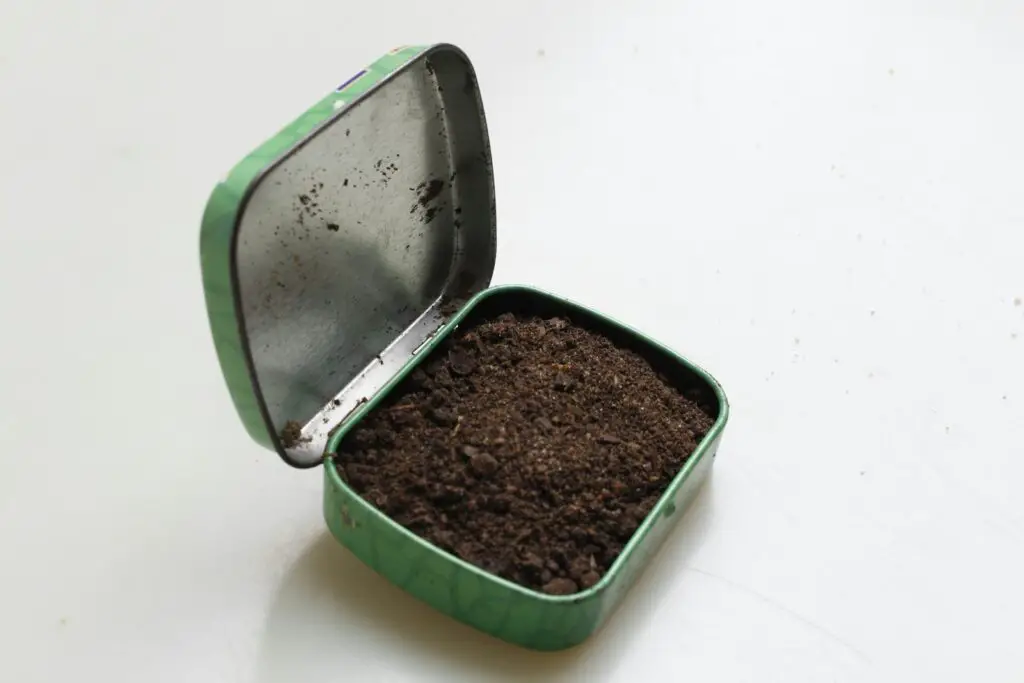 brown soil in green metal box